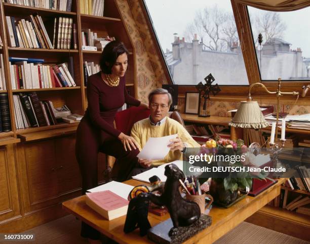 Rendezvous With Olivier Orban And His Wife Christine. A Paris, Olivier ORBAN, assis à son bureau regardant une feuille de papier avec son épouse...