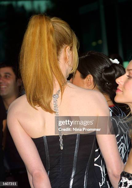 Actress Nicole Kidman sporting a fashion chain that extends down her back attends the premiere of "The Others" August 7, 2001 at the Directors Guild...