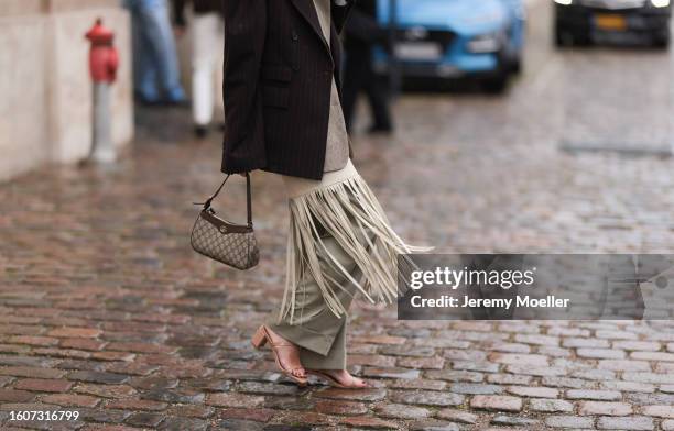 Guest seen wearing latte white and cream leather fringed long dress, beige oversized blazer jacket, brown striped puffy blazer jacket, beige wide leg...