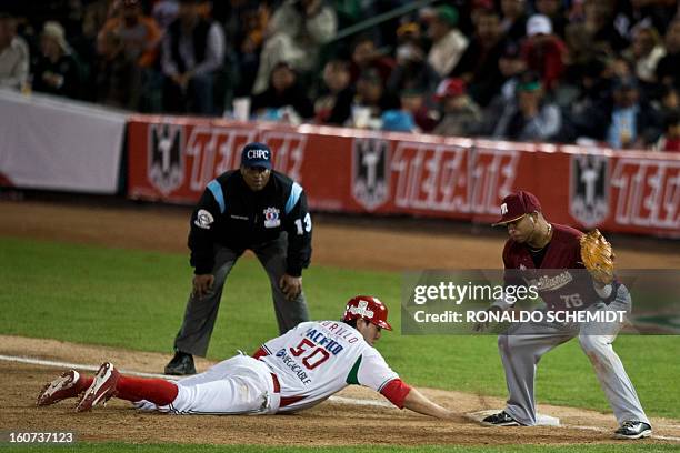 Agustin Murillo of Yaquis de Obregon of Mexico slides safe at first base against Magallanes of Venezuela during the 2013 Caribbean baseball series on...