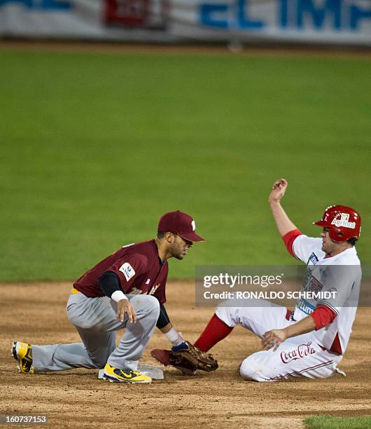 Reegie Corona of Magallanes of Venezuela tags out Agustin Murillo of Yaquis de Obregon of Mexico on second base during the 2013 Caribbean baseball...