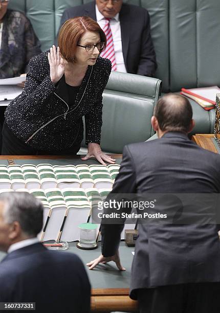 Prime Minister Julia Gillard and Opposition leader Tony Abbott speak prior to House of Representatives question time at Parliament House on February...