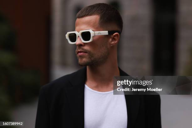 Kevin Elezaj seen wearing A Cold Wall latte / white cream sunglasses, silver earrings white cotton tank top, Filippa K black blazer jacket, during...