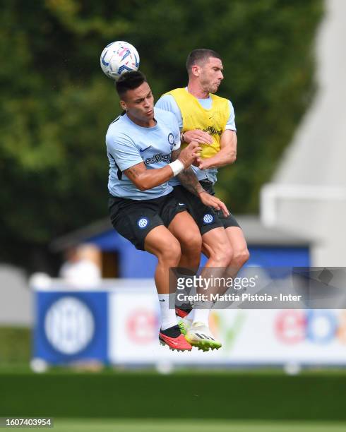 Lautaro Martinez of FC Internazionale and Robin Gosens of FC Internazionale compete for the ball during a team training session at the club's...