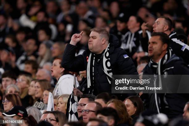 Collingwood fans react during the round 22 AFL match between Collingwood Magpies and Geelong Cats at Melbourne Cricket Ground, on August 11 in...