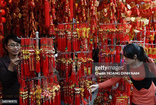 This picture taken on February 4, 2013 shows a customer browsing Chinese decorative hanging items for the lunar new year or Tet celebrations at a Tet...