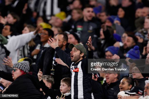 Collingwood fans react during the round 22 AFL match between Collingwood Magpies and Geelong Cats at Melbourne Cricket Ground, on August 11 in...