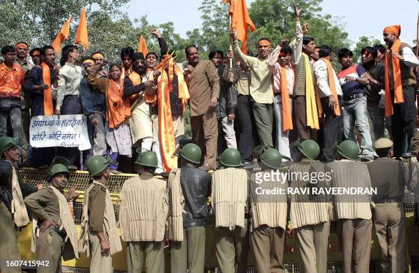 Hindu right wing Shiv Sena activits shout slogans as Delhi Policemen prevent them to march to the parliament in New Delhi, 06 December 2002. Hundred...