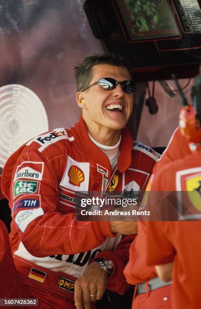 German racing driver Michael Schumacher wearing sunglasses and red coveralls, ahead of the Hungarian Grand Prix, held at the Hungaroring, in...