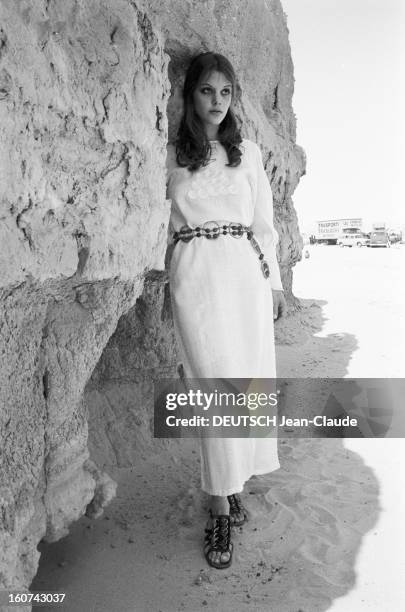 Tina Aumont Shows Spring 1971 Paris Fashion In Tunisia. En Tunisie, à Nefta, Tina AUMONT, appuyée contre une paroi rocheuse, présentant pour la...