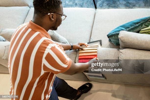 choosing furniture colors by himself - fabric swatch stock pictures, royalty-free photos & images