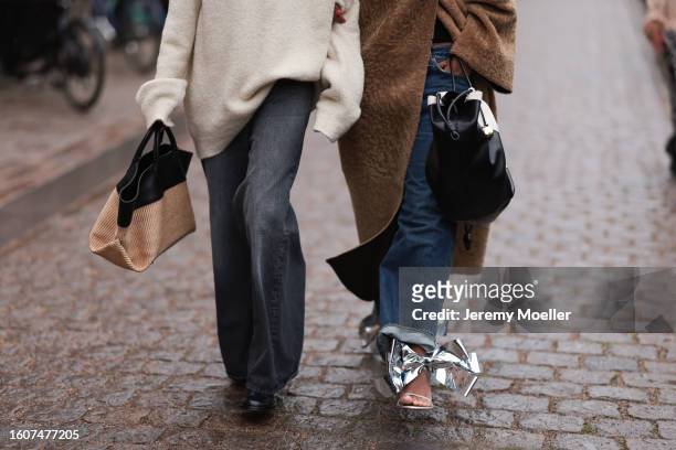 Hanna MW seen wearing brown teddy coat, oversized dark blue jeans, silver bow Loewe sandals and black and white Loewe handbag, Guest seen wearing...