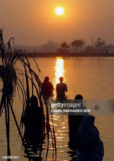 Hindu devotees worship the setting sun on the occasion of Chhath Puja near Ranchi 21 November 2001. Millions of worshippers in India's eastern state...
