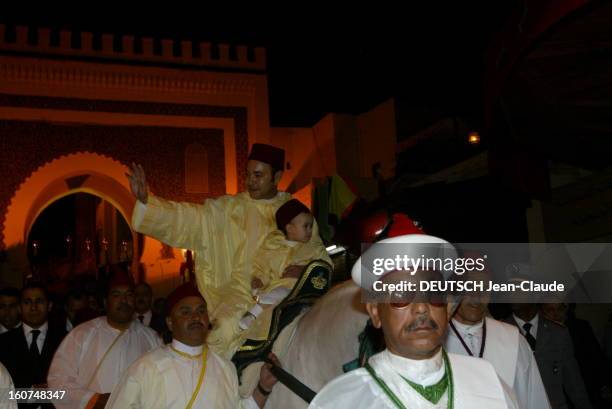 Circumcision Of The Crown Prince Of Morocco. Le roi MOHAMMED VI saluant la foule, avec son fils le prince MOULAY HASSAN, se rendant à cheval au...