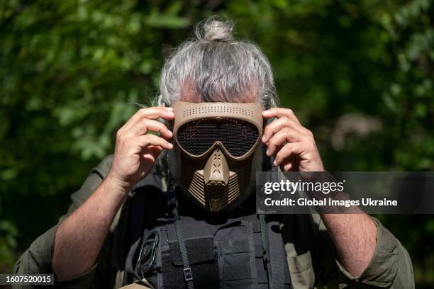 Man puts on an mask in airsoft exercises on June 22, 2023 in Donetsk Oblast, Ukraine. With the help of airsoft, soldiers practice the skills of...