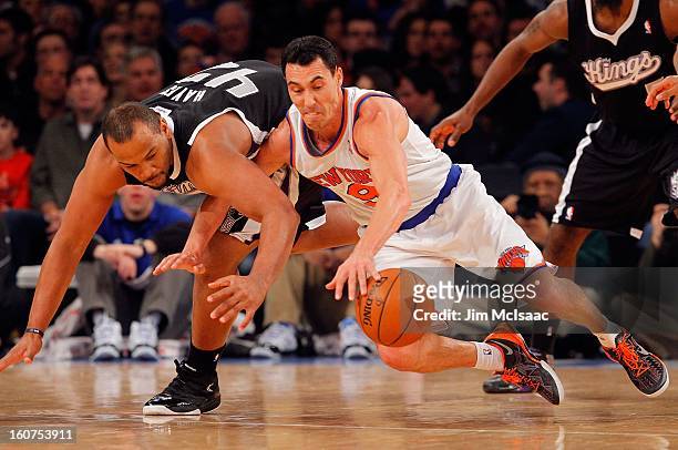 Pablo Prigioni of the New York Knicks battles for a loose ball against Chuck Hayes of the Sacramento Kings at Madison Square Garden on February 2,...