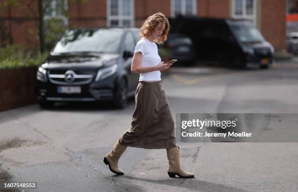 Mathilde Marie Holst Roien seen wearing white t-shirt, beige / brown midi skirt and Copenhagen Studios CPH233 Suede Sand suede leather boots, on...