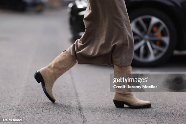 Mathilde Marie Holst Roien seen wearing beige / brown midi skirt and Copenhagen Studios CPH233 Suede Sand leather boots, on August 10, 2023 in...