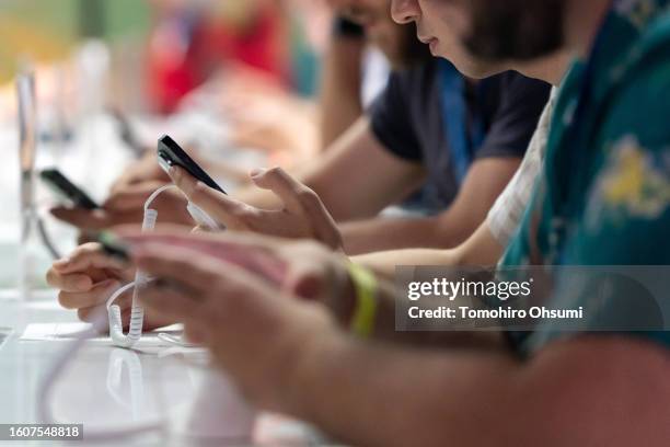 Competitors play the Pokémon GO game during the 2023 Pokémon World Championships at the Pacifico Yokohama convention center on August 11, 2023 in...