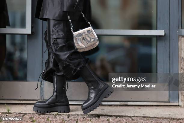 Naomi Anwer seen wearing black oversized blazer, matching black cargo pants, silver metallic bag and Copenhagen Studios CPH685 Vitello Black leather...