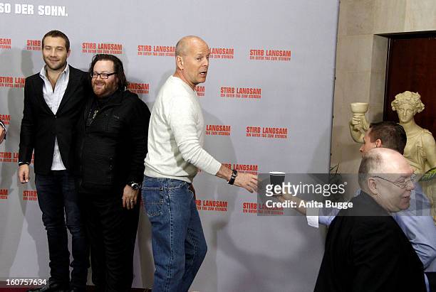 Actor Jai Courtney, director John Moore and actor Bruce Willis attend the 'Die Hard - Ein Guter Tag Zum Sterben' Berlin photocall at Adlon Hotel on...
