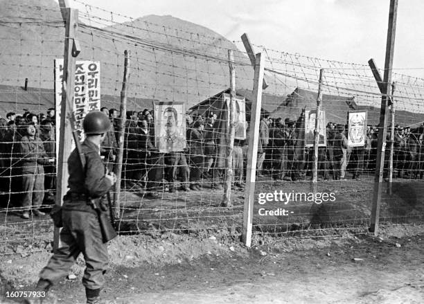 Protesting Chinese and North Korean prisoners display portraits of communist leaders Stalin, Mao Tse-Tung and Kim il-Sung on March 09, 1952 at Koje...