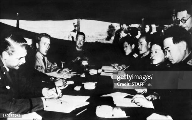 Picture taken in 1951 at Pan Mun Jom of Communists and US liaison officers discussing an armistice. United States and China supported respectively...