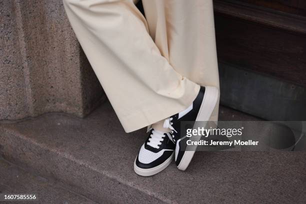 Jean Claude Mpassy seen wearing cream white pants and Copenhagen Studios CPH1M Leather Mix Black leather sneaker, on August 10, 2023 in Copenhagen,...