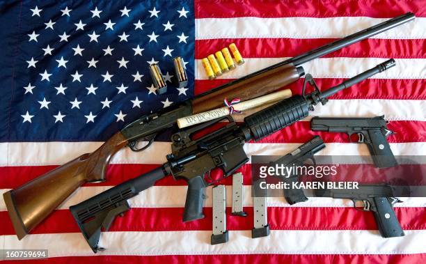This February 4, 2013 photo illustration in Manassas, Virginia, shows a Remington 20-gauge semi-automatic shotgun, a Colt AR-15 semi-automatic rifle,...