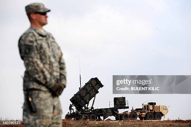 Soldier stands in front of a Patriot missile system at a Turkish military base in Gaziantep on February 5, 2013. The United States, Germany and the...