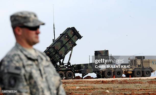 Soldier stands in front of a Patriot missile system at a Turkish military base in Gaziantep on February 5, 2013. The United States, Germany and the...