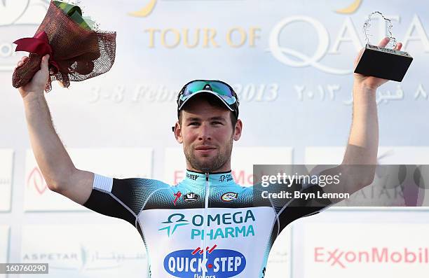 Mark Cavendish of Great Britain and Omega Pharma - Quick Step stands on the podium after winning stage three of the Tour of Qatar from Al Wakra to...