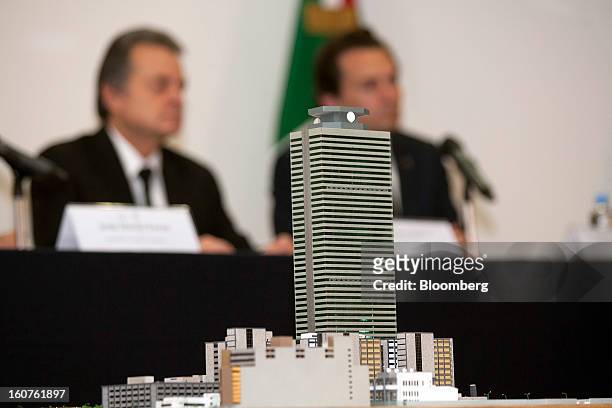 Model of the Petroleos Mexicanos administrative building sits in the foreground while Pedro Joaquin Coldwell, Mexico's energy minister, left, and...