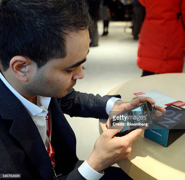 Customer Jay Charnalia sets up his new Blackberry Z10 device on the first day of sales at a Rogers Communications Inc. Store in Toronto, Ontario,...