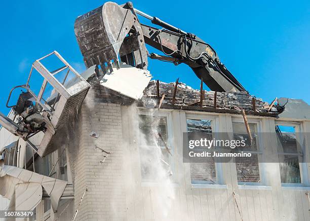 a building being demolished by a large bulldozer - smashing stock pictures, royalty-free photos & images