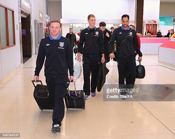 In this handout image provided by The FA, Wayne Rooney, Joe Hart and Joleon Lescott board a train as the England squad travel to London on February...