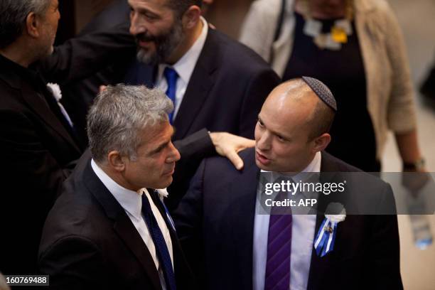 Israeli politician Yair Lapid , head of Yesh Atid party embrace Naftali Bennett, head of the Israeli hardline national religious party the Jewish...