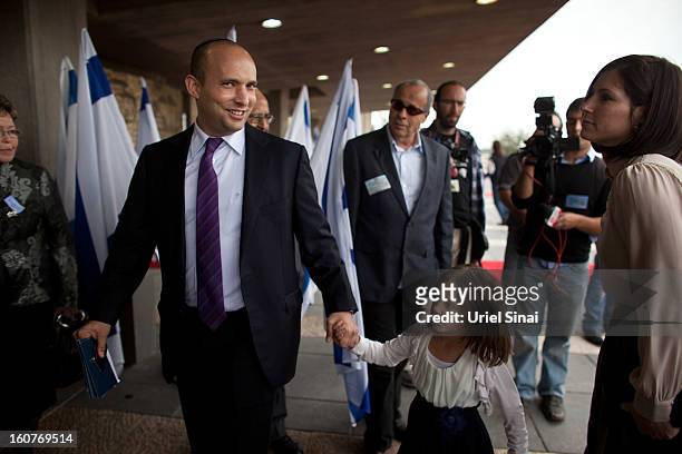 Naftali Bennett, head of the Israeli hardline national religious party the Jewish Home arrives with his wife and daughter to a reception marking the...