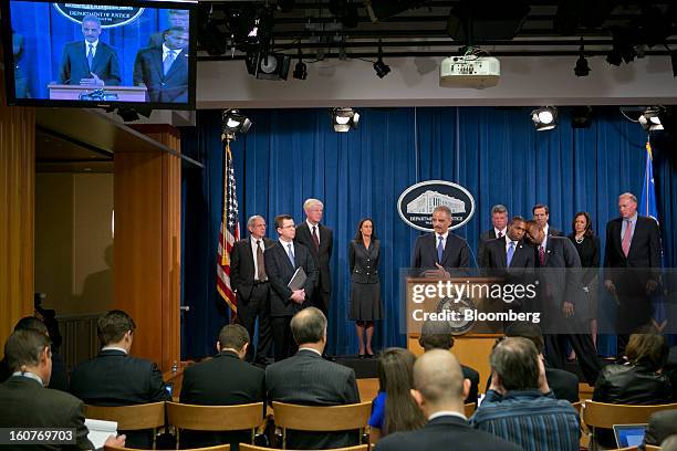 Eric Holder, U.S. Attorney general, center, speaks during a news conference with Irvin Nathan, District of Columbia attorney general, left to right,...