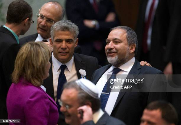 Yair Lapid , head of Yesh Atid party, stands next to former foreign minister, Avigdor Lieberman of the Likud-Beitenu coalition after the swearing-in...