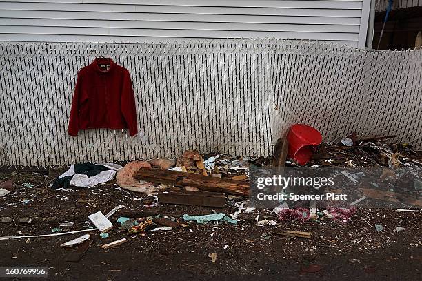 Clothes and other debris are viewed outside of a destroyed home in Oakwood Beach in Staten Island on February 5, 2013 in New York City. In a program...