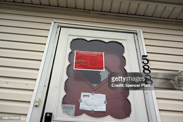 Sign on the door of a flood damaged home notifies that the area is unsafe in Oakwood Beach in Staten Island on February 5, 2013 in New York City. In...
