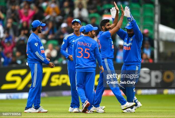 Dublin , Ireland - 18 August 2023; Jasprit Bumrah of India, second from right, celebrates with wicketkeeper Sanju Samson after taking the wicket of...