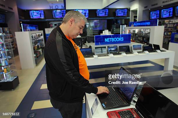 Sergio Feldman checks out a Dell computer on display at the Electric Avenue store on February 5, 2013 in Miami, Florida. Dell Inc. Today announced it...
