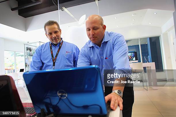 Paul Brener and David Tabb check out a Dell computer on display at the Electric Avenue store on February 5, 2013 in Miami, Florida. Dell Inc. Today...