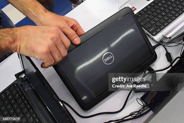 Customer looks at a Dell computer on display at the Electric Avenue store on February 5, 2013 in Miami, Florida. Dell Inc. Today announced it will be...