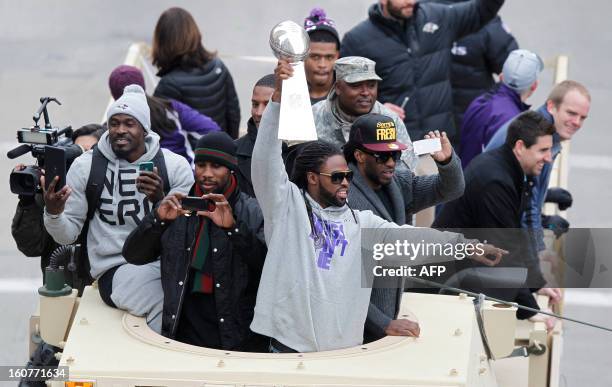 Wide receiver Torrey Smith of the Super Bowl champion Baltimore Ravens, hoists the Vince Lombardi trophy as he and his teammates take part in the...