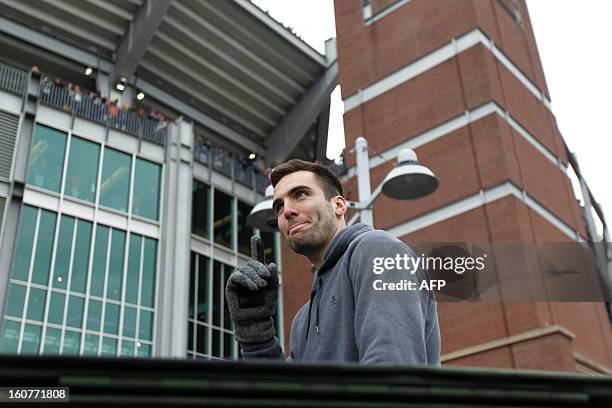 Quarterback Joe Flacco of the Super Bowl champion Baltimore Ravens greets fans during the Ravens victory parade and rally in Baltimore, Maryland on...