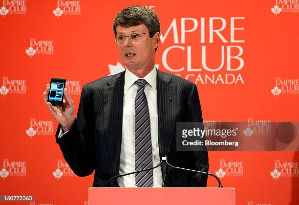 Thorsten Heins, chief executive officer of BlackBerry, displays a Z10 device while speaking during an event at the Empire Club of Canada in Toronto,...