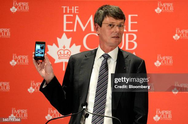 Thorsten Heins, chief executive officer of BlackBerry, displays a Z10 device while speaking during an event at the Empire Club of Canada in Toronto,...